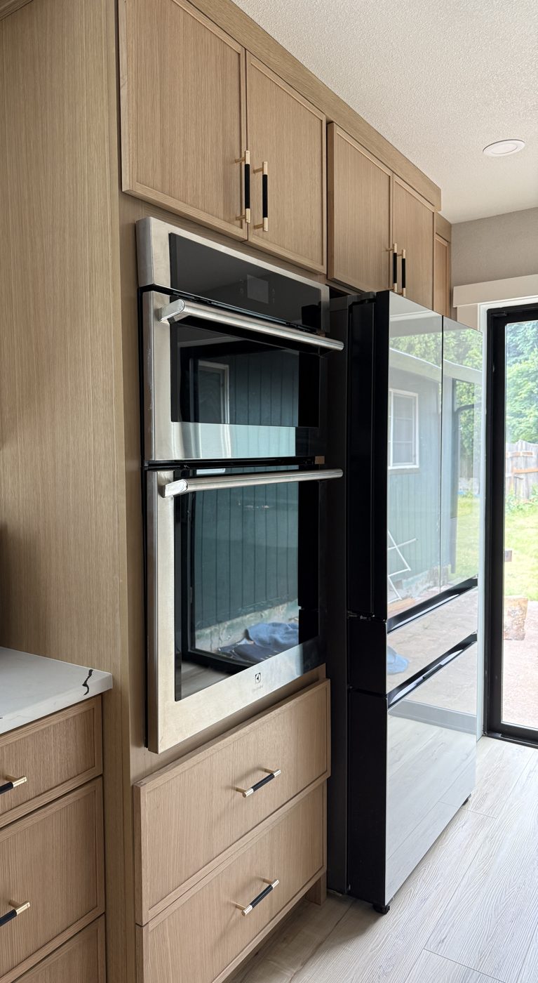 White oak oven tower with black and brass pulls