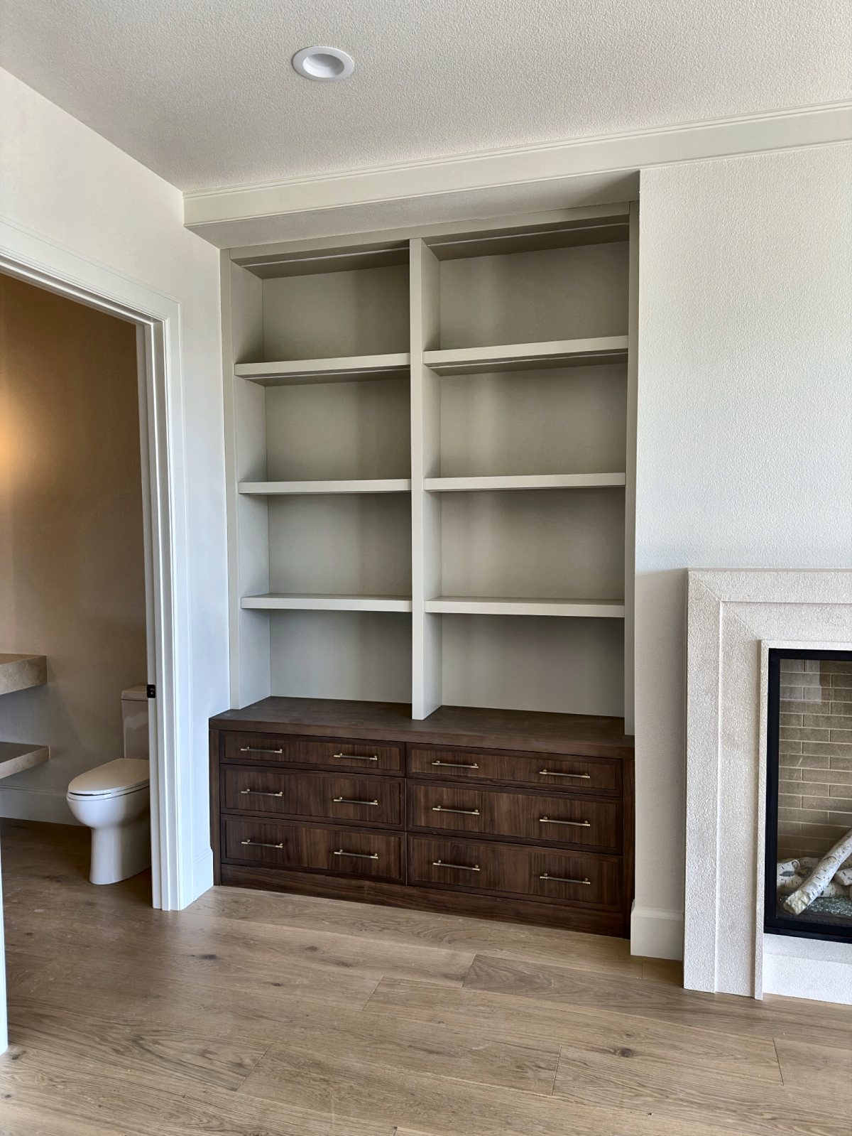 Painted bookshelves over a walnut drawer base